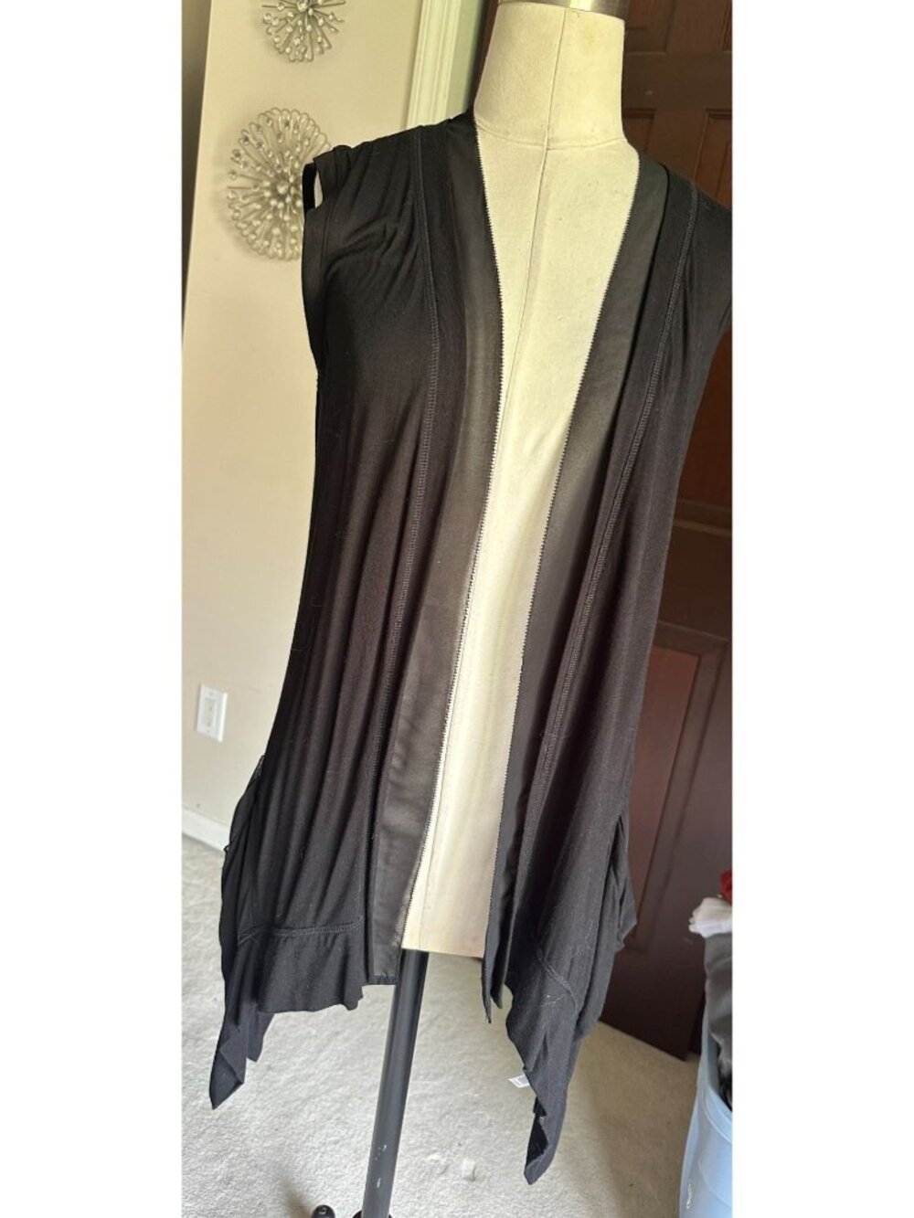 black Lori Goldstein vest with dramatic asymmetrical "sharkbite" hem and sheer c